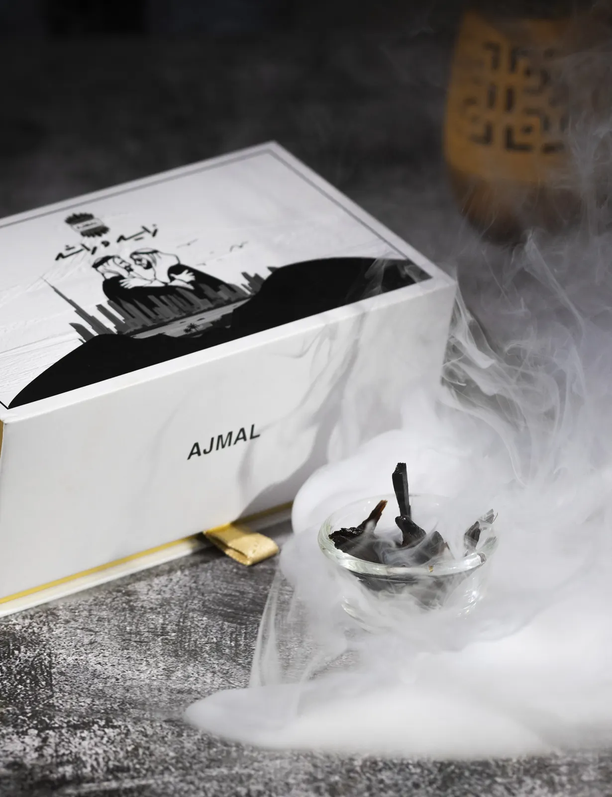 An Ajmal perfume bottle wrapped in smoke